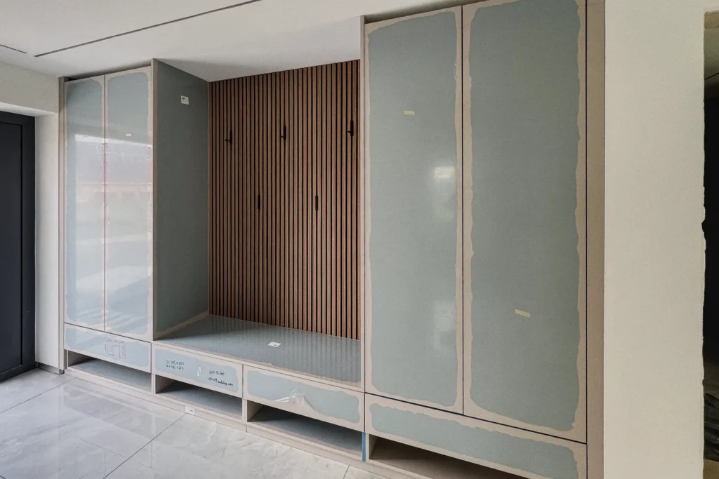 Einbauschrank mit Glastüren, Schubladen und Holzlamellen im Küchenbereich